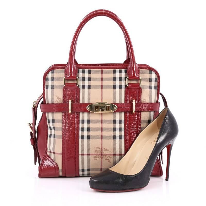 This authentic Burberry Minford Satchel Haymarket Coated Canvas Medium is luxurious with a dash of sophistication perfect for chic casual wear. Crafted in the brand's haymarket check coated canvas with red leather trims, this satchel features