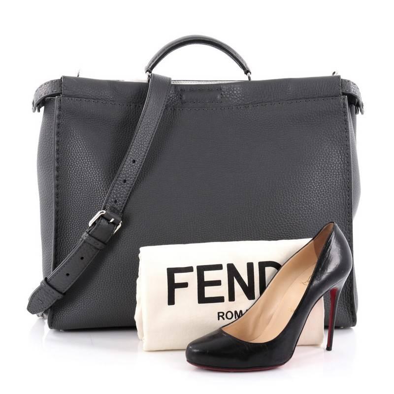 This authentic Fendi Peekaboo Monster Handbag Mixed Media Large is a stand-out, carry-all piece updating its classic Peekaboo style. Crafted from luxurious grey leather, this stylish tote features its eye-catching yellow monster eye applique design,
