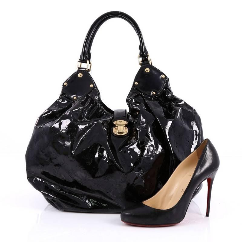 This authentic Louis Vuitton XL Hobo Surya Leather is sleek and refined in design apt for the modern woman. Crafted from LV’s black patent monogram leather, this oversized sun-inspired hobo features dual-rolled handles, buckle and stud details,
