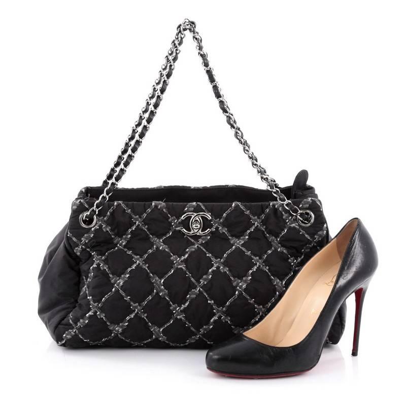 This authentic Chanel Tweed on Stitch Tote Quilted Nylon Large is stylish and unique for the Spring 2011 collection. Crafted from black nylon in Chanel's trademark diamond quilting with quilted tweed, this adorable bag features dual woven-in leather