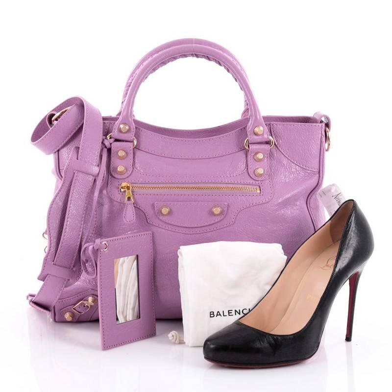 This authentic Balenciaga Velo Giant Studs Handbag Leather is a chic, feminine everyday bag. Crafted from lavender leather, this stylish and functional tote features dual-rolled whipstitched handles, signature Balenciaga giant studs and buckle