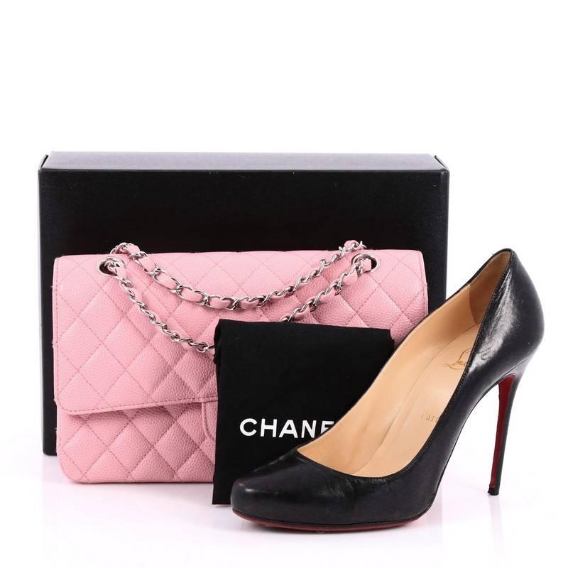 This authentic Chanel Classic Double Flap Bag Quilted Caviar Medium exudes a classic yet easy style made for the modern woman. Crafted from pink caviar leather, this elegant flap features Chanel's signature diamond quilted design, woven-in leather