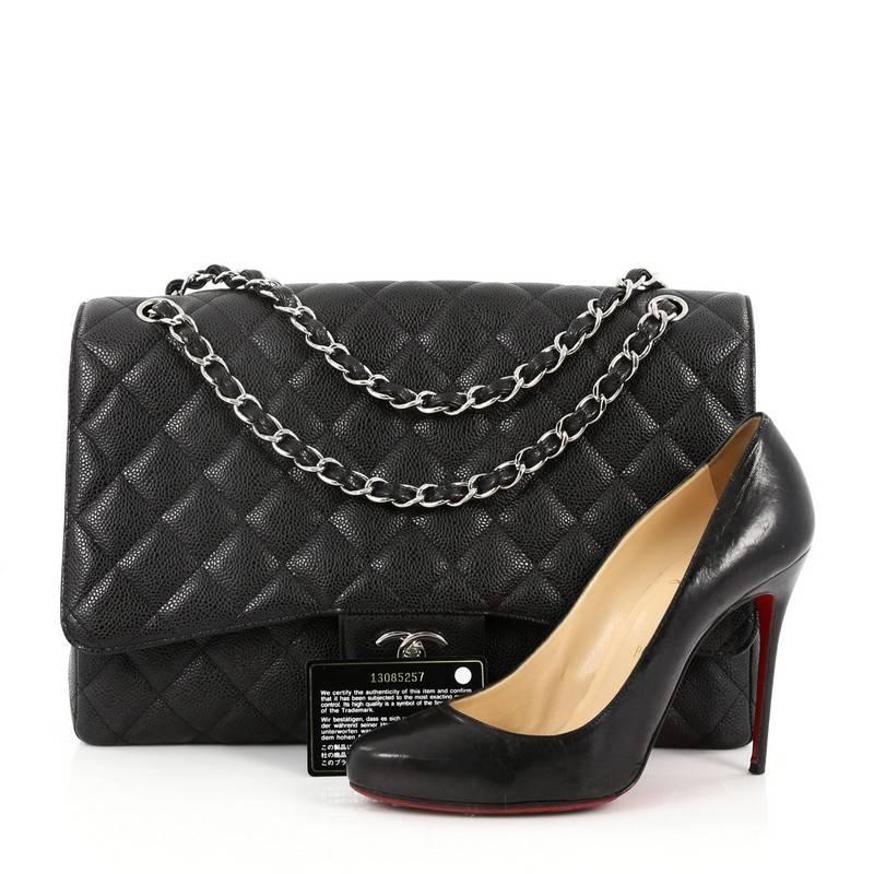 This authentic Chanel Classic Single Flap Bag Quilted Caviar Maxi is a timeless essential for any modern woman. Crafted in black quilted caviar leather, this classic flap features woven-in leather chain strap, exterior back pocket, CC signature