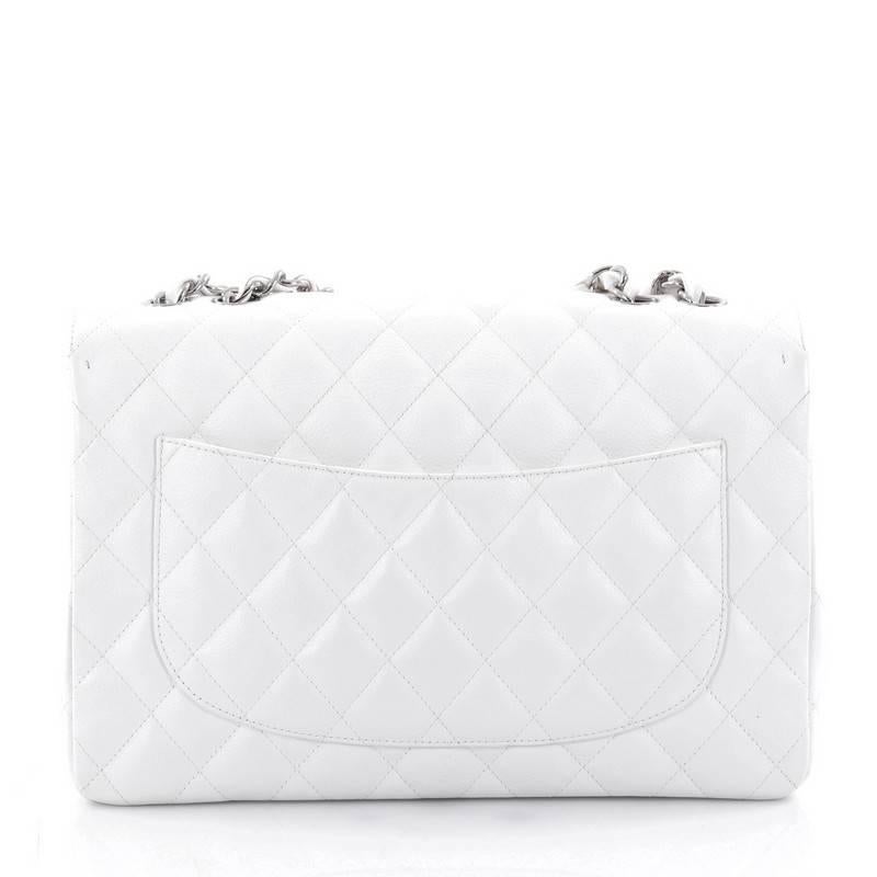 This authentic Chanel Vintage Classic Single Flap Bag Quilted Caviar Jumbo is a timeless essential for any modern woman. Crafted from beautiful white lambskin leather, this coveted classic flap features Chanel's signature diamond quilting design,