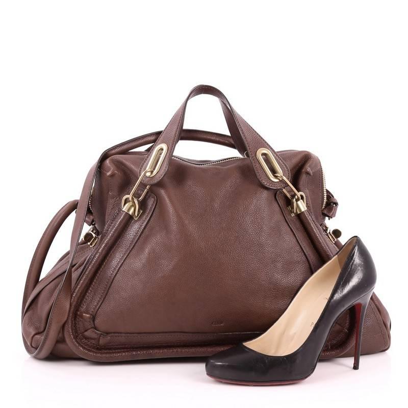 This authentic Chloe Paraty Top Handle Bag Leather Large mixes everyday style and functionality perfect for the modern woman. Crafted from brown leather, this versatile bag features piped trim details, dual flat handles, side twist locks, and