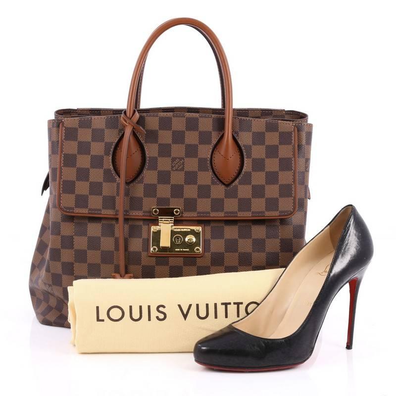 This authentic Louis Vuitton Ascot Handbag Damier is sophisticated and functional made for everyday use or light traveling. Crafted from damier ebene with nomade calf leather trims, this structured tote features dual-rolled leather handles, exterior