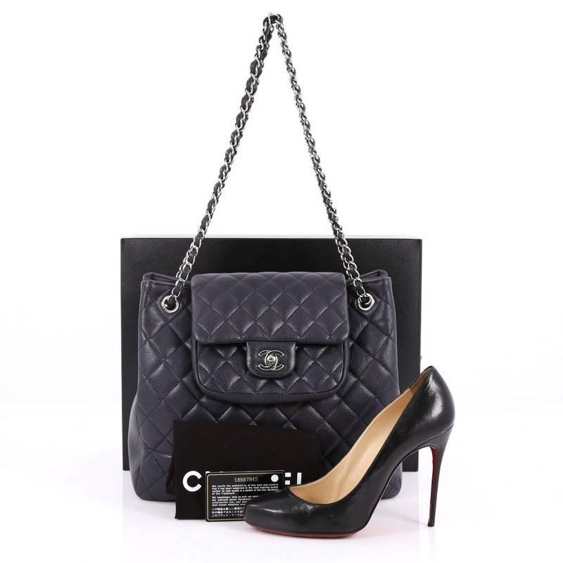 This authentic Chanel Classic Flap Shopping Tote Quilted Caviar Medium presents a classic and timeless style made for any fashionista. Constructed in luxurious navy blue diamond quilted caviar leather, this chic tote features a simple silhouette,