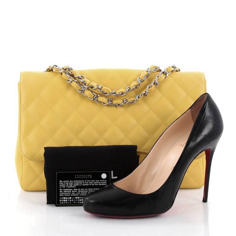 This authentic Chanel Classic Single Flap Bag Quilted Caviar Jumbo is a timeless essential for any modern woman. Crafted in yellow quilted caviar leather, this classic flap features woven-in leather chain strap, exterior back pocket, CC signature