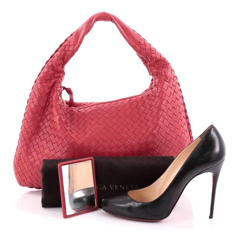 This authentic Bottega Veneta Veneta Hobo Intrecciato Nappa Medium is a timelessly elegant bag with a casual silhouette. Excellently crafted from red nappa leather woven in Bottega Veneta's signature intrecciato method, this no-fuss hobo features a