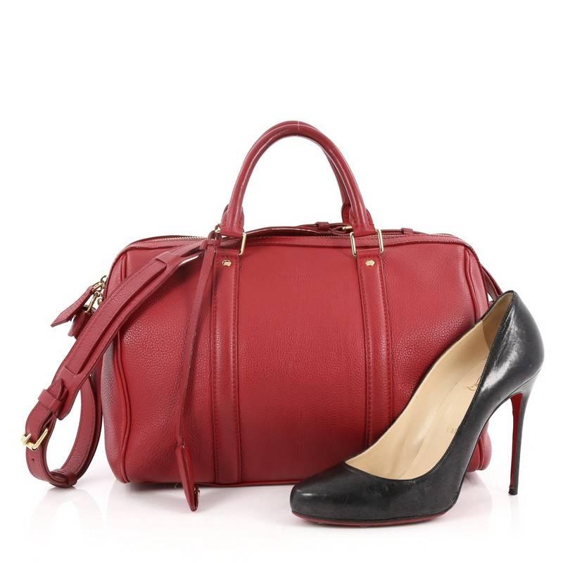This authentic Louis Vuitton Sofia Coppola SC Bag Leather PM is a stylish and elegant everyday bag. Crafted from red leather, this simple yet refined duffle bag features sturdy rolled handles, adjustable shoulder strap, protective base studs and