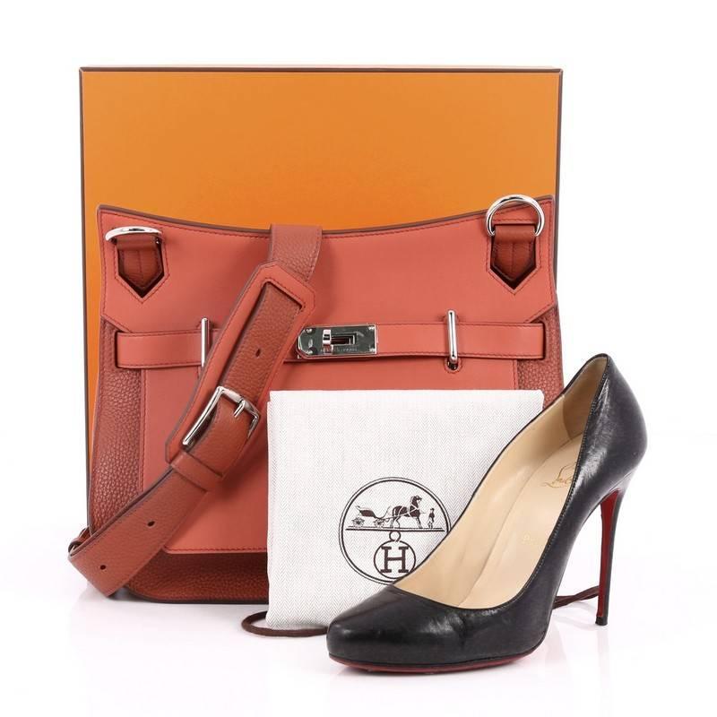 This authentic Hermes Jypsiere Handbag Bicolor Clemence and Swift 31 inspired by its iconic Kelly bag is a current and favorite style among Hermes lovers. Crafted from bicolor brique and sanguine leather, this luxurious messenger features flat