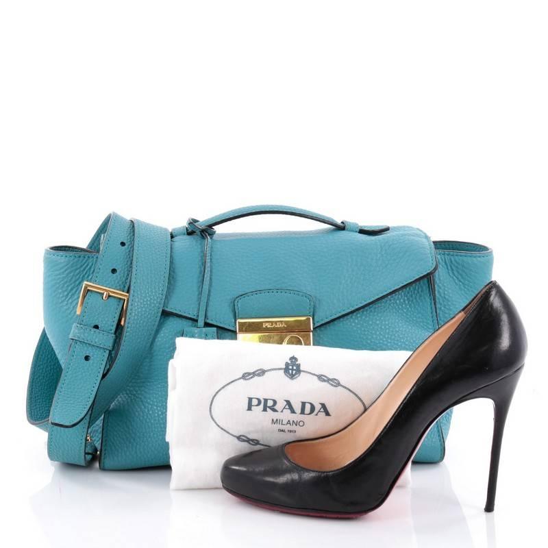 This authentic Prada Pattina Convertible Shoulder Bag Vitello Daino Medium is one sophisticated piece. Crafted from blue vitello daino leather, this compact bag features flat top handle, detachable shoulder strap, exterior side pockets, exterior