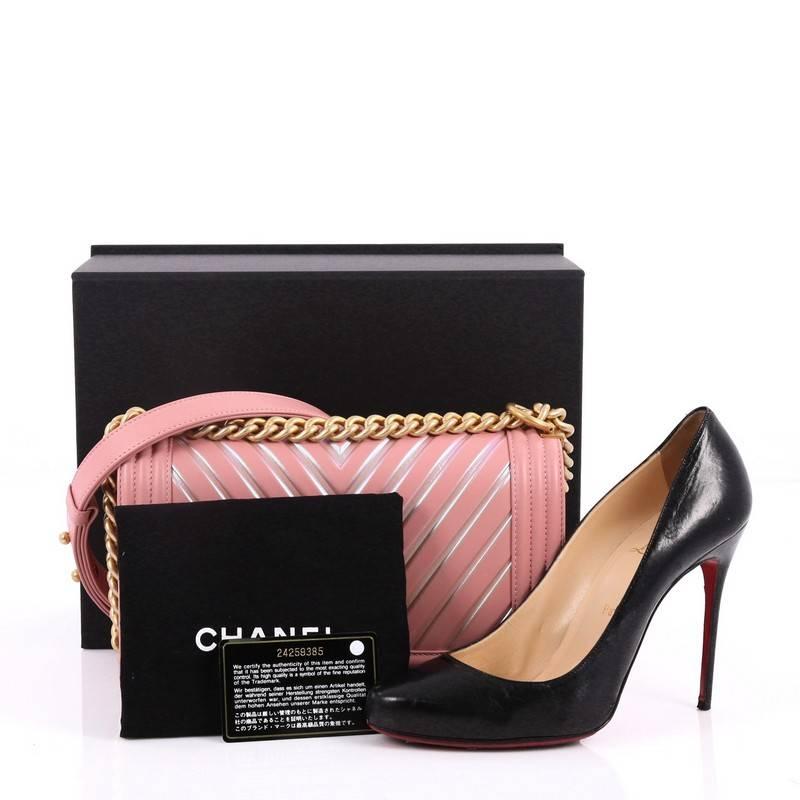 This authentic Chanel Boy Flap Bag Chevron Painted Calfskin Old Medium combines classic Chanel craftsmanship with definitive style fit for the contemporary fashionista. Crafted from pink painted calfskin leather, this luxurious and enviable Boy bag