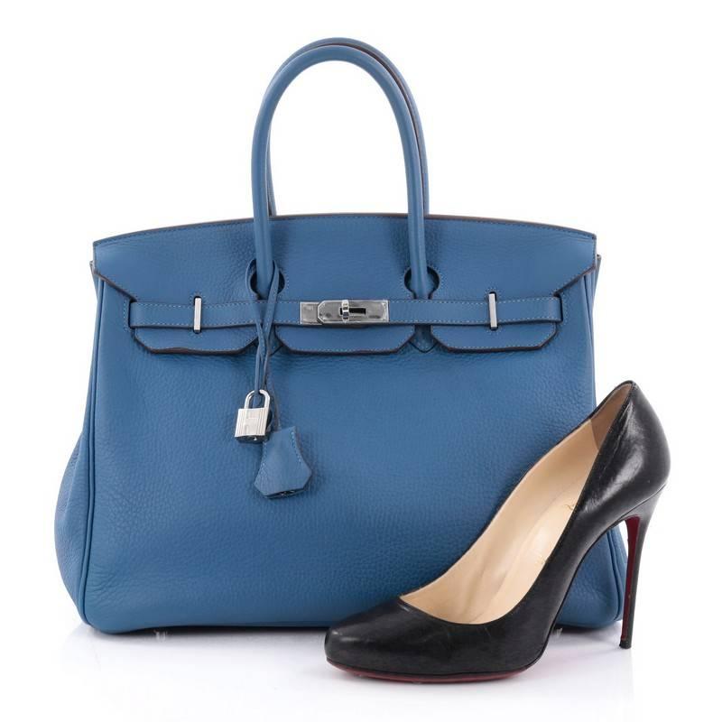 This authentic Hermes Birkin Handbag Blue Mykonos Clemence with Palladium Hardware 35 stands as one of the most-coveted and timeless bags fit for any fashionista. Uniquely constructed from scratch-resistant blue mykonos clemence leather, this subtly