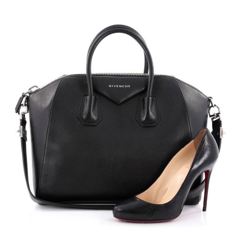 This authentic Givenchy Antigona Bag Leather Medium is a go-to fashion favorite. Crafted from black leather, this structured yet stylish tote features the brand's signature envelope flap detail with Givenchy logo, dual-rolled leather handles and