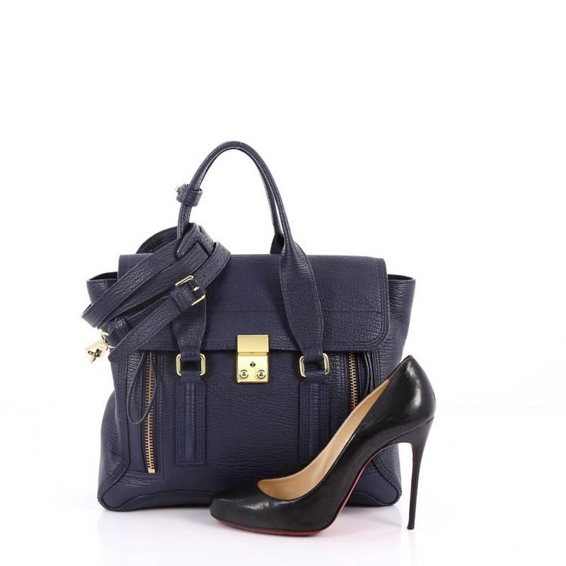 This authentic 3.1 Phillip Lim Pashli Satchel Leather Medium is a practical bag with a stylish edge made for on-the-go moments. Crafted from blue leather, this chic satchel features dual top handles, expandable zip sides, top flap push-lock closure