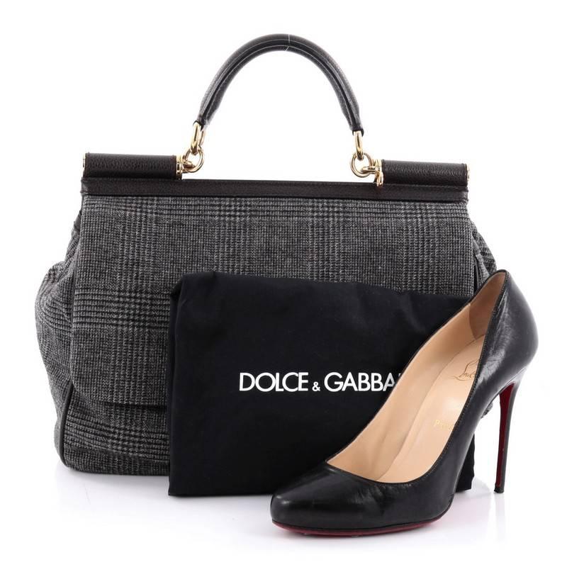 This authentic Dolce & Gabbana Miss Sicily Handbag Wool Large pays homage to the designers' Sicilian heritage with a fresh twist. Crafted from gray wool, this bag features leather top handle, designer plaque, and gold-tone hardware accents. Its