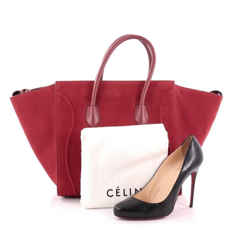 This authentic Celine Phantom Handbag Suede Medium is one of the most sought-after bags beloved by fashionistas. Crafted from red suede, this minimalist tote features dual-rolled handles, an exterior front pocket, protective base studs, stamped logo