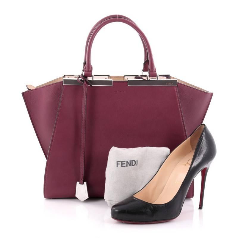This authentic Fendi Petite 3Jours Handbag Leather is an impeccably stylish update from its popular predecessor the 2Jour tote. Crafted from maroon leather, this tote features the popular side wings, shining silver-tone split top bar that dons the