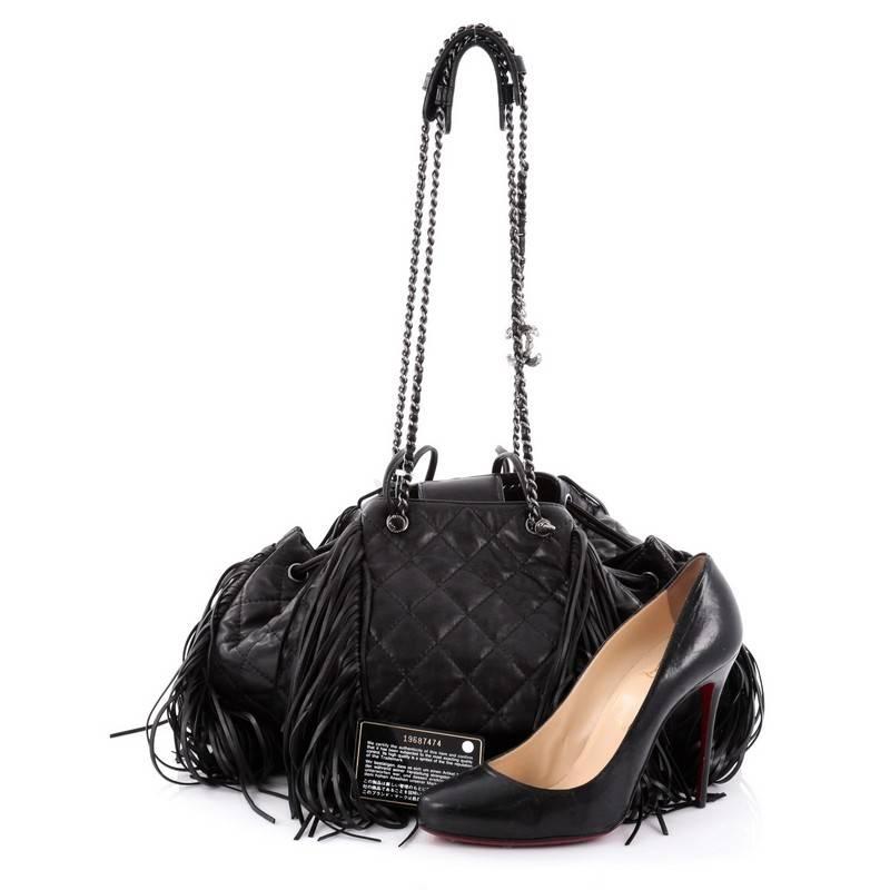 This authentic Chanel Paris-Dallas Drawstring Fringe Shoulder Bag Quilted Leather Large presented in the brand's Paris-Dallas Metiers d'Art 2013-2014 Collection mixes avant-garde Parisian sophistication with a touch of western americana styling.