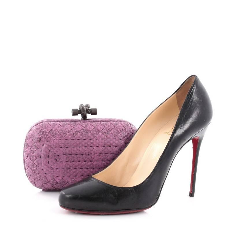 This authentic Bottega Veneta Box Knot Clutch Python Small is a simple yet stunning accessory for any formal event. Crafted from genuine purple python with standout contrast stitching and the brand's signature woven intrecciato method detailing,