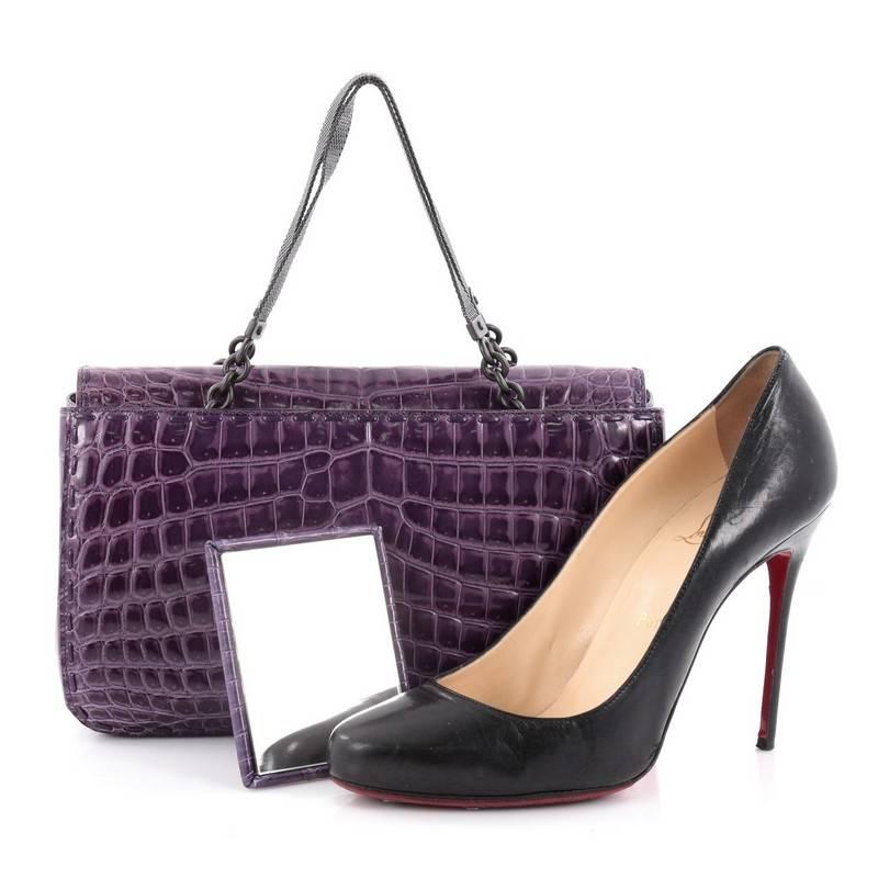 This authentic Bottega Veneta Open Tote Crocodile Small is a statement piece you can surely take from day to night. Beautifully crafted in genuine purple crocodile skin, this stylish tote features dual metal mesh and chain handles, exterior back