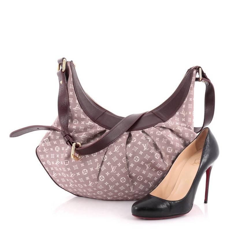 This authentic Louis Vuitton Rhapsodie Handbag Monogram Idylle MM is a versatile pleated hobo perfect for everyday uses. Constructed in a beautiful burgundy monogram idylle canvas, this chic bag features burgundy adjustable leather shoulder straps