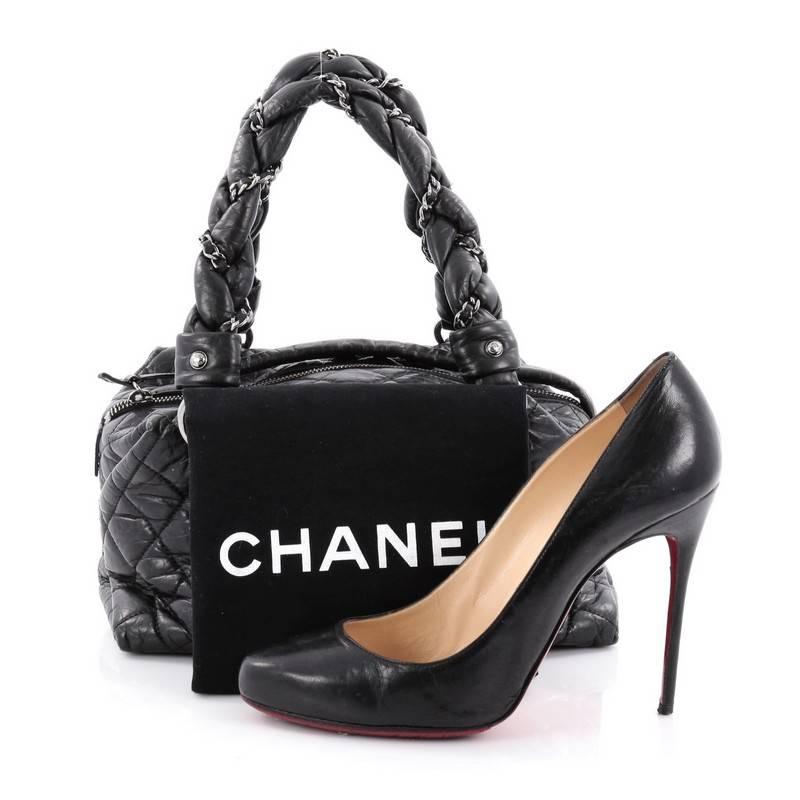 This authentic Chanel Lady Braid Bowler Bag Quilted Leather Small is perfect for the on-the-go fashionista. Constructed from black diamond quilted leather, this petite tote features intertwined woven leather chain straps, side silver mademoiselle CC