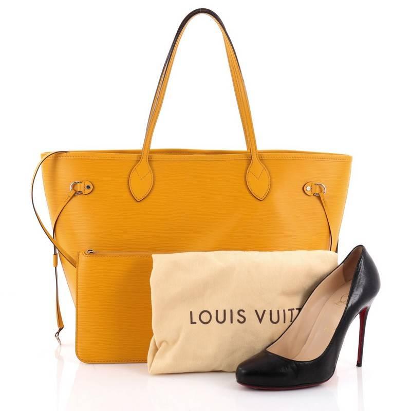 This authentic Louis Vuitton Neverfull Tote Epi Leather MM is a perfect companion for daily excursions. Crafted in yellow epi leather, this iconic, easy-to-carry tote features dual flat leather handles, side tassels that cinch and expands and