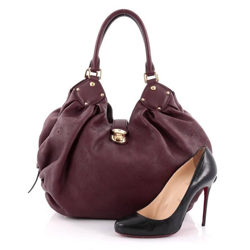 This authentic Louis Vuitton L Hobo Mahina Leather is sleek and refined in design apt for the modern woman. Crafted in burgundy perforated monogram mahina leather, this feminine hobo features dual-rolled handles, buckle and stud details, side belt