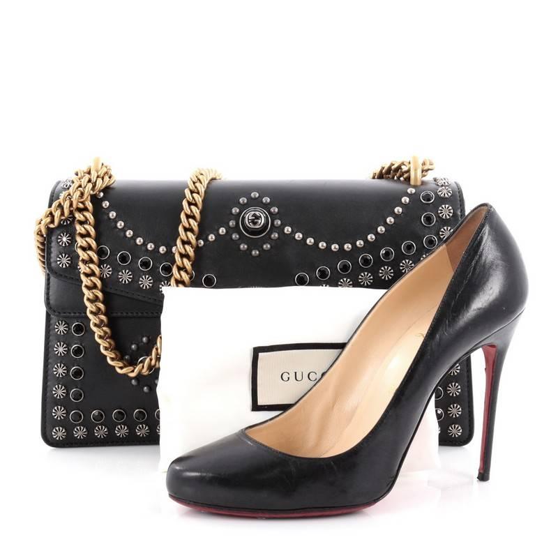 This authentic Gucci Dionysus Handbag Studded Leather Small named after the Greek God is a stunning piece. Crafted from black leather, this satchel features multiple black crystal and metal studs, aged gold chain link strap, textured tiger head spur