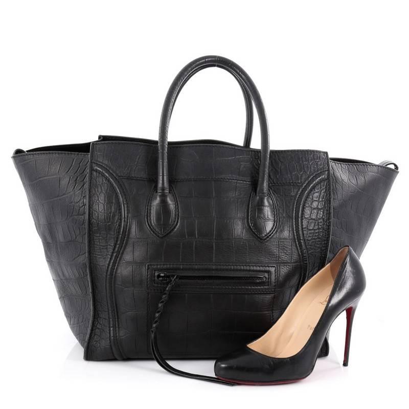 This authentic Celine Phantom Handbag Crocodile Embossed Leather Large is one of the most sought-after bags beloved by fashionistas. Crafted from black crocodile embossed leather, this minimalist tote features dual-rolled handles, an exterior front