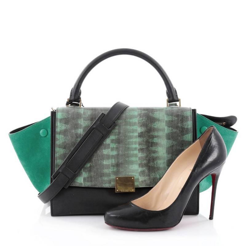 This authentic Celine Tricolor Trapeze Handbag Tiger Snake and Leather Small is a modern minimalist design with a playful twist in an array of subdued colors. Crafted from genuine green tiger snake and black leather with green suede side wings and,