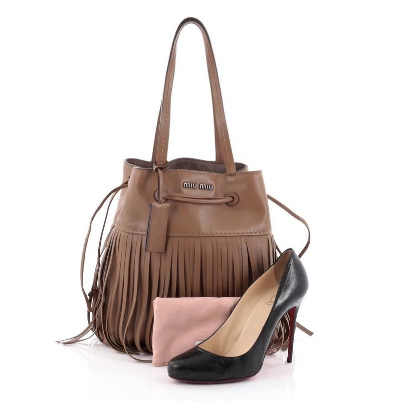 This authentic Miu Miu Fringe Shoulder Bag Leather Medium displays a bohemian detailing for a stylish and practical bag that'll see you through all four seasons. Crafted from medium brown leather, this bag features dual flat leather handles,