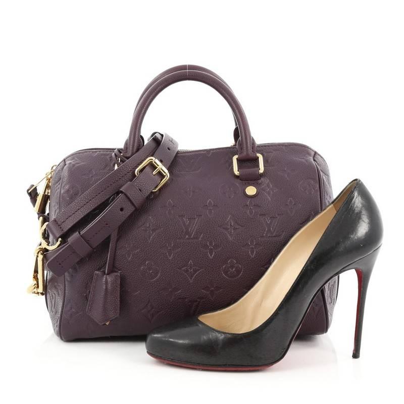 This authentic Louis Vuitton Speedy Bandouliere Bag Monogram Empreinte Leather 25 is a modern must-have. Constructed from Louis Vuitton's luxurious purple monogram empreinte leather, this iconic and re-imagined Speedy features dual-rolled leather