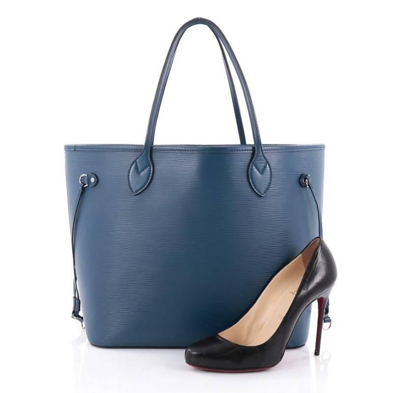 This authentic Louis Vuitton Neverfull Tote Epi Leather MM is a perfect companion for daily excursions. Crafted in blue epi leather, this iconic, easy-to-carry tote features dual flat leather handles, side tassels that cinches and expands and