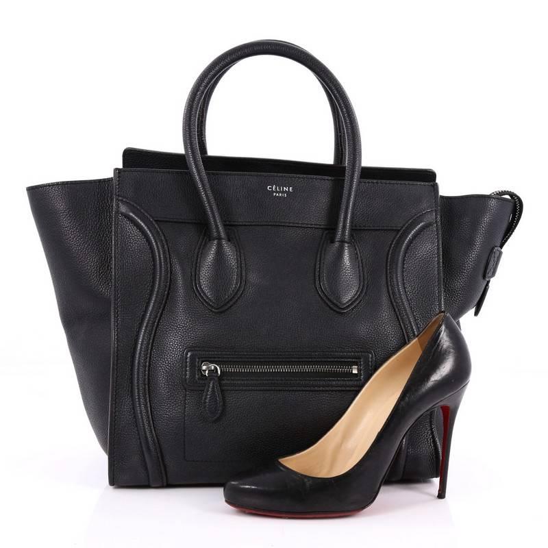 This authentic Celine Luggage Handbag Grainy Leather Mini epitomizes Phoebe Philo's minimalist yet chic style. Constructed in black grainy leather, this beloved fashionista's bag features dual-rolled leather handles, a frontal zip pocket, Celine's