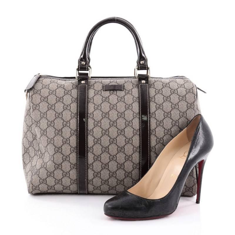 This authentic Gucci Joy Boston Bag GG Coated Canvas Medium is a simple and stylish companion perfect for daily excursions. Crafted in Gucci's taupe GG monogram coated canvas with brown patent leather trimmings, this bag features dual-rolled handles