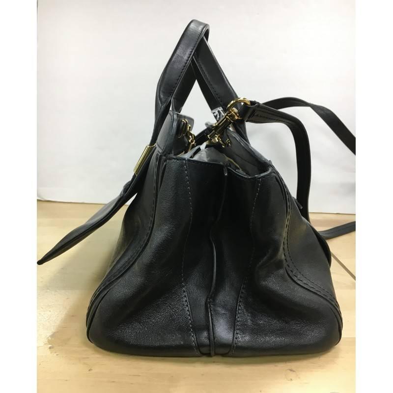This authentic Chloe Alice Satchel Leather Medium is a casual-cool piece made for everyday excursions. Crafted from black leather, this no-fuss, luxurious satchel features dual-rolled handles, front flap pocket, expansive sides wings, and gold-tone