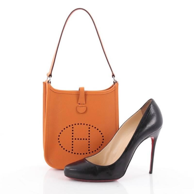 This authentic Hermes Short Strap Evelyne Shoulder Bag Epsom TPM showcases a playful size perfect for daily, lightweight excursions. Crafted from orange leather, this petite bag is accented with Hermes' perforated H at the front and includes a