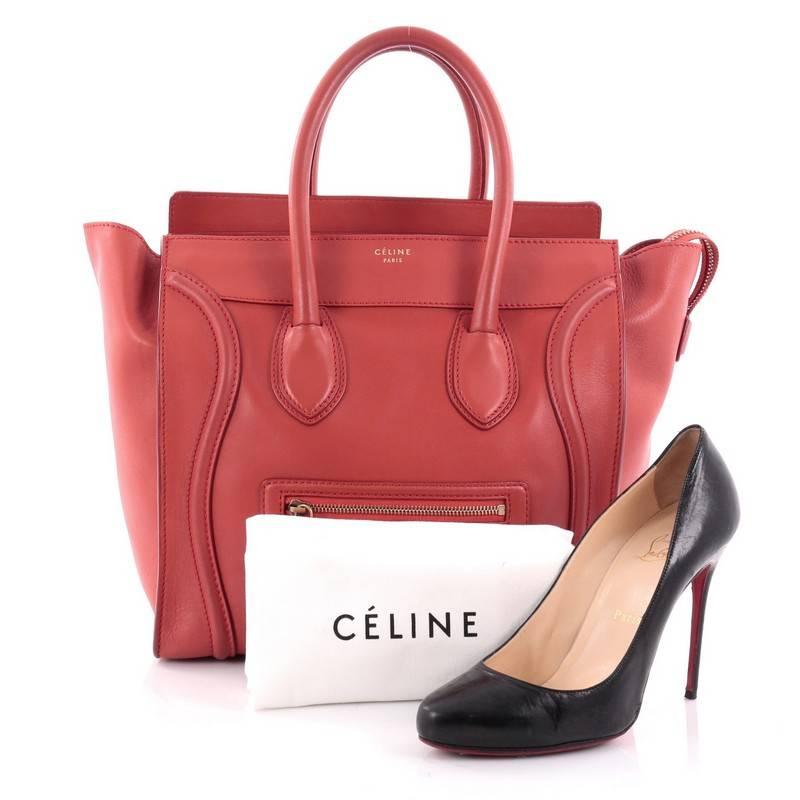 This authentic Celine Luggage Handbag Smooth Leather Mini epitomizes Phoebe Philo's minimalist yet chic style. Constructed in red smooth leather, this beloved fashionista's bag features dual-rolled leather handles, a frontal zip pocket, protective