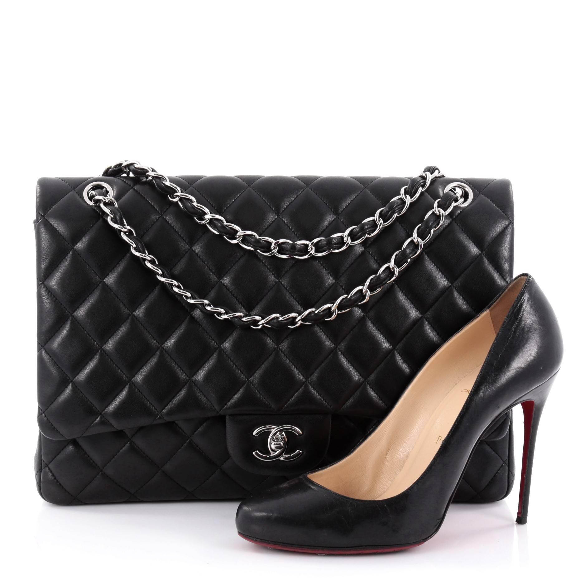 This authentic Chanel Classic Single Flap Bag Quilted Lambskin Maxi exudes a classic yet easy style made for the modern woman. Crafted from black quilted lambskin leather, this elegant flap features Chanel's signature diamond quilted design,