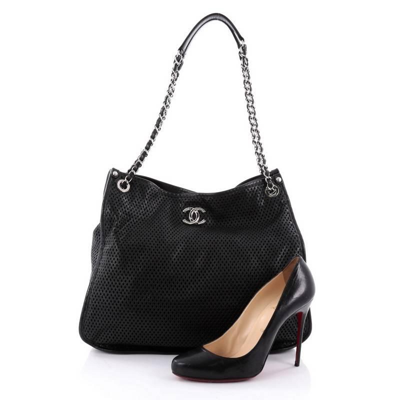 This authentic Chanel Up In The Air Tote Perforated Leather, showcased in Chanel's Spring 2013 Collection, is a perfect understated companion for everyday excursions. Crafted in sleek black diamond laser-cut leather, this sports-inspired tote