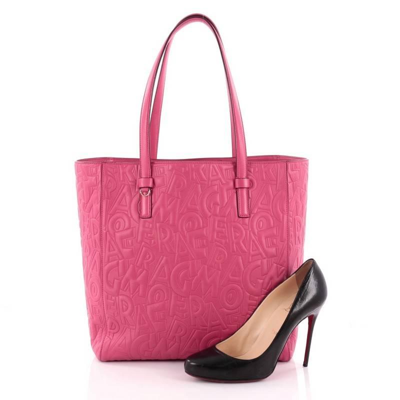 This authentic Salvatore Ferragamo Bonnie Lettering Tote Embossed Leather Large is a spacious everyday bag that is a fantastic addition to any collection. Crafted from pink logo embossed leather, this timeless tote features dual flat leather