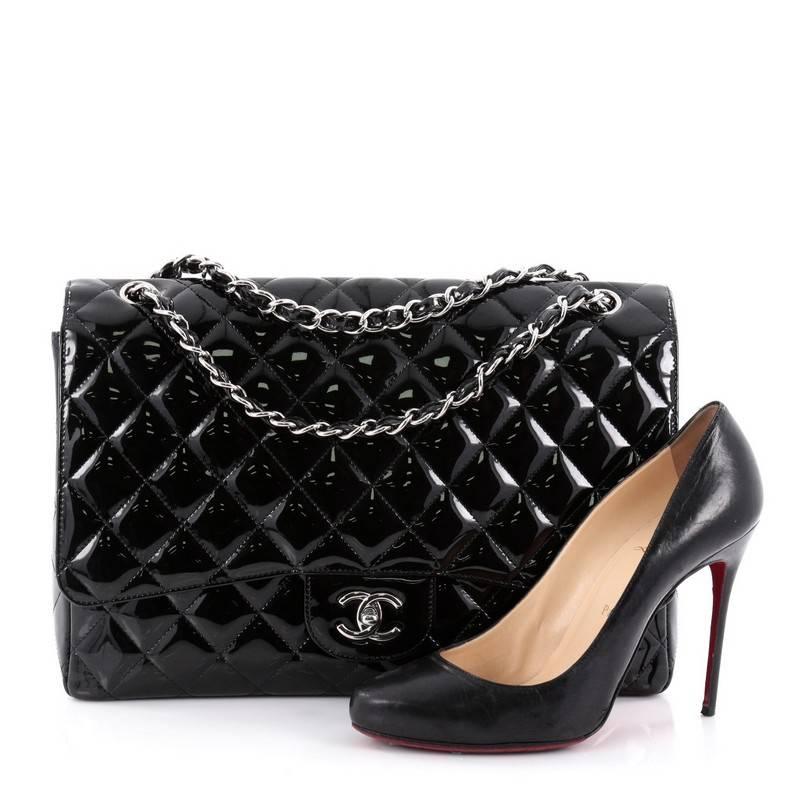 This authentic Chanel Classic Single Flap Bag Quilted Patent Maxi is a timeless essential for any modern woman. Crafted in black quilted patent leather, this classic flap features woven-in leather chain strap, exterior back pocket, CC signature