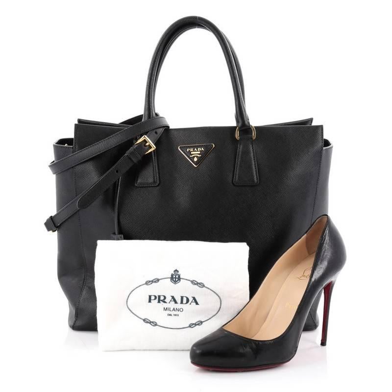 This authentic Prada Zip Convertible Tote Saffiano Leather Medium is elegant in its simplicity and structure. Crafted from black saffiano leather, this sturdy and spacious tote features dual-rolled handles, iconic inverted Prada triangle logo at the