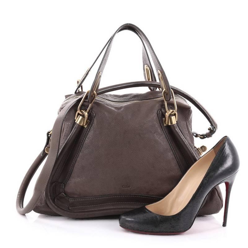 This authentic Chloe Paraty Top Handle Bag Leather Medium mixes everyday style and functionality perfect for the modern woman. Crafted from brown leather, this versatile bag features dual flat handles, piped trim details, side twist locks, and