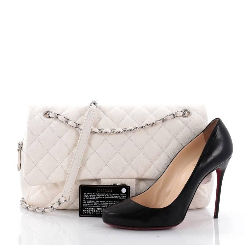 This authentic Chanel Easy Flap Bag Quilted Caviar Jumbo exudes a classic yet easy style made for the modern woman. Crafted from off-white caviar leather with Chanel's signature diamond quilting design, this elegant flap features dual woven-in