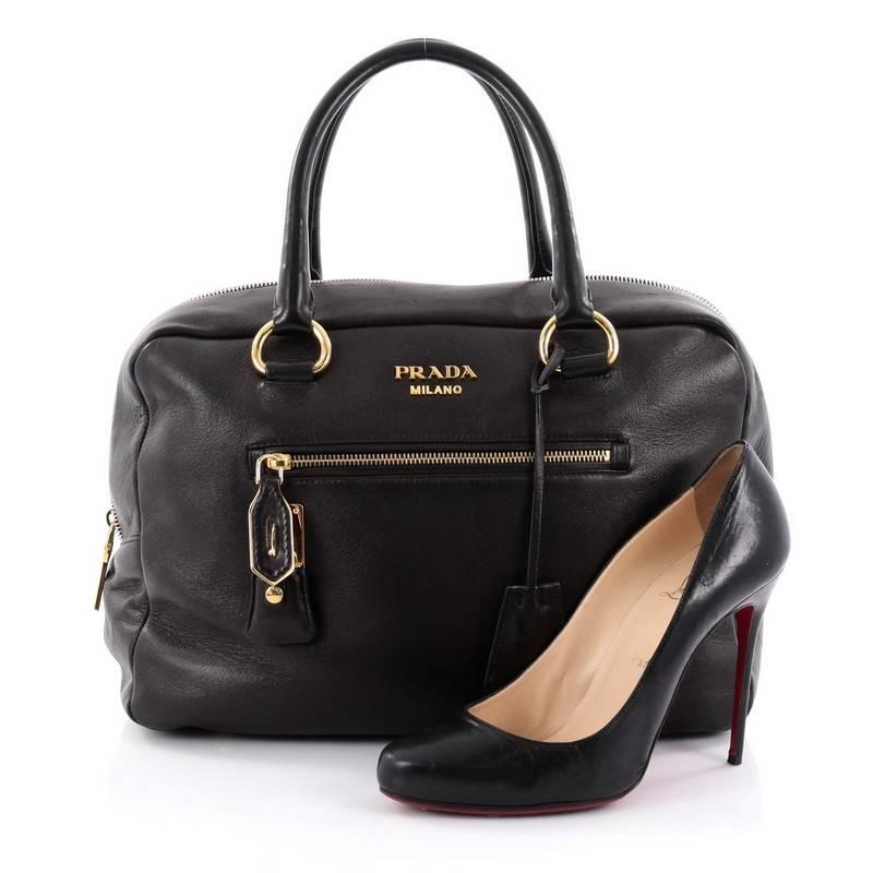 This authentic Prada Zippers Front Pocket Bowler Glace Calf Medium is elegant in its simplicity and structure. Crafted in black glace calf leather, this sleek bowler features dual-rolled handles, exterior front and back zip pocket, protective base