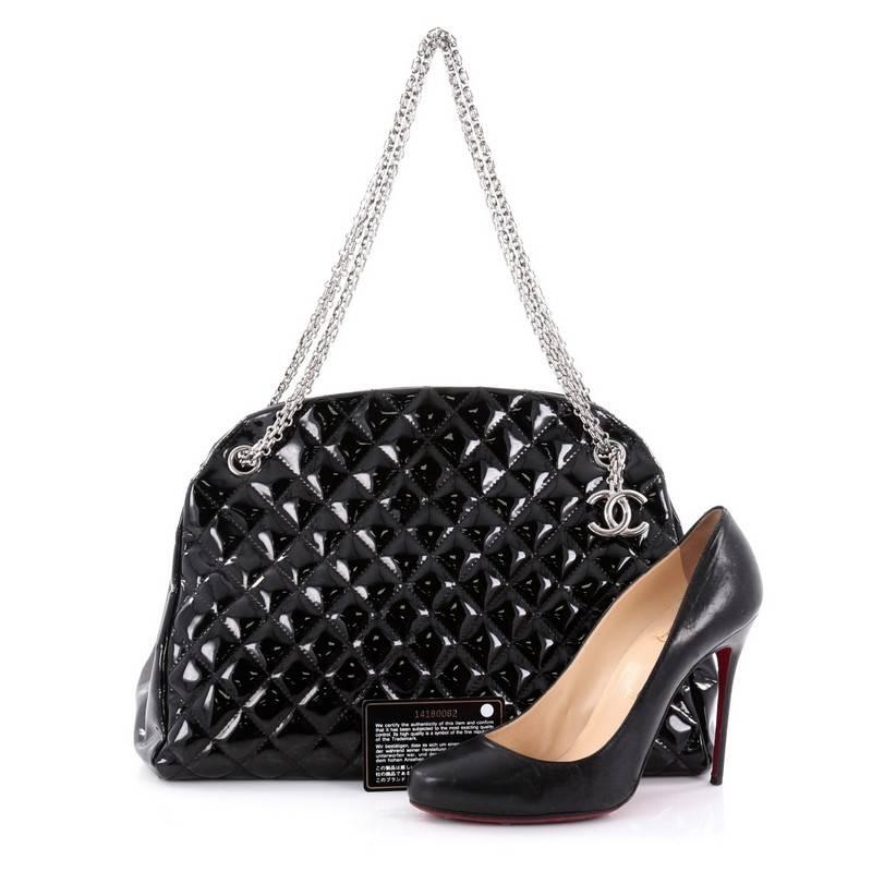 This authentic Chanel Just Mademoiselle Quilted Patent Large showcases a sleek style that complements any look. Crafted from beautiful black patent leather in Chanel's iconic diamond stitch pattern, this bag features Chanel Reissue Chain straps,
